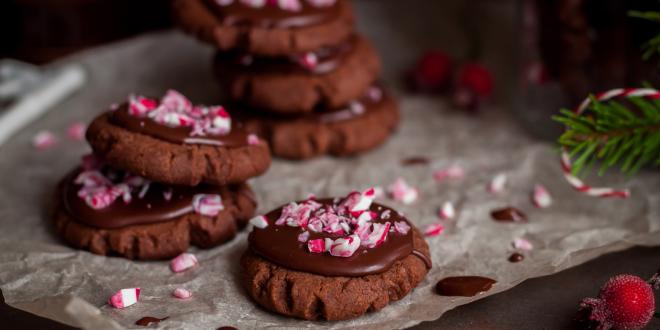 a plate of chocolate cookies with crushed candy canes